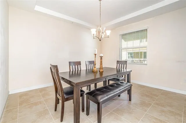 a view of a dining room with furniture and a chandelier