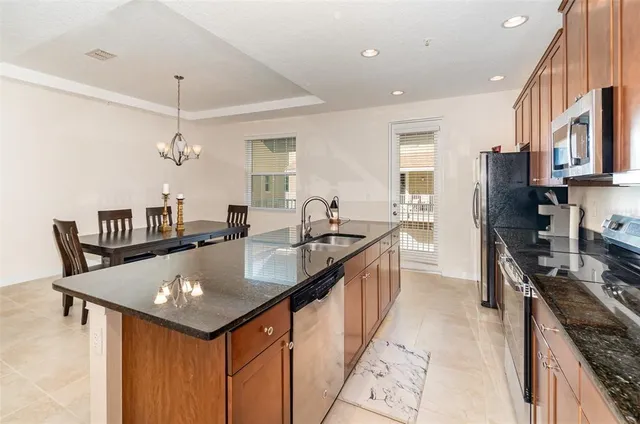 a kitchen with counter space a sink and appliances