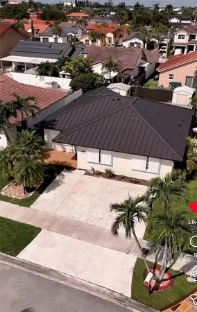 an aerial view of a house with a yard