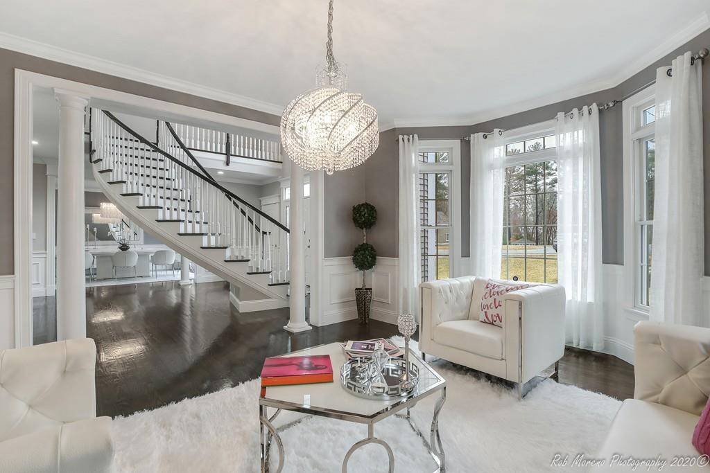 13 Pollock Drive Middleton, MA 01949 - Photo 3 of 42 a living room with furniture chandelier and a large window