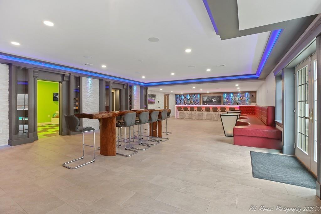 13 Pollock Drive Middleton, MA 01949 - Photo 37 of 42 a living room with furniture a floor to ceiling window and a flat screen tv