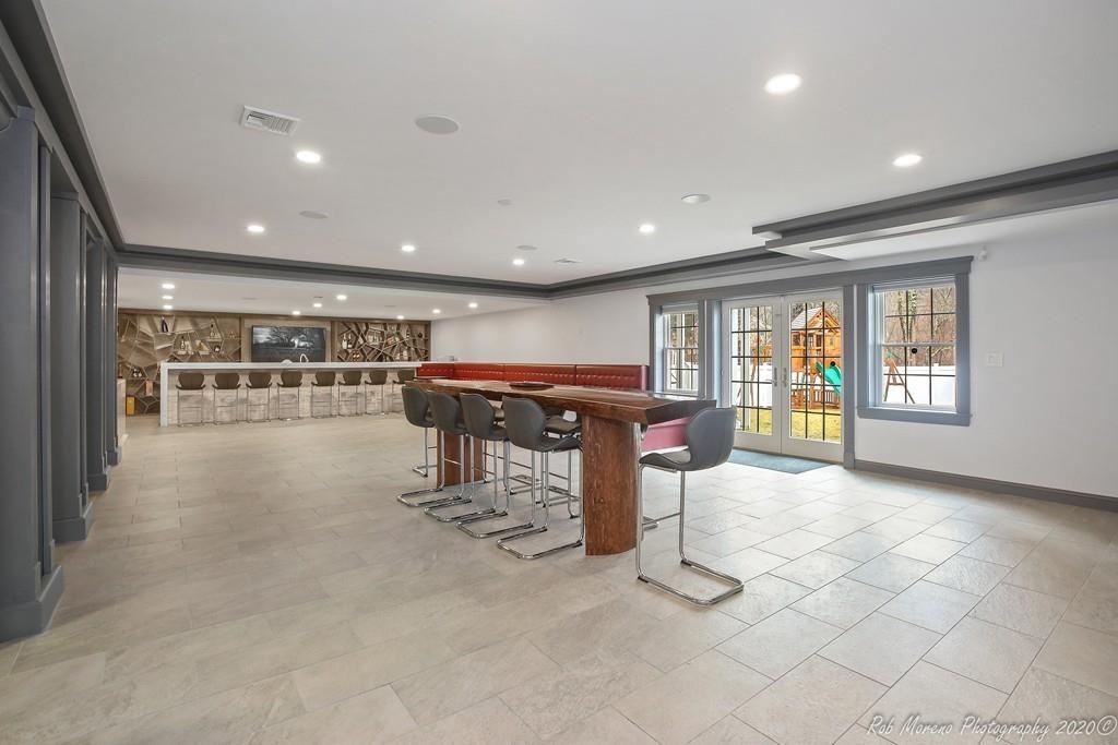 13 Pollock Drive Middleton, MA 01949 - Photo 40 of 42 a room with lots of furniture and a view of kitchen