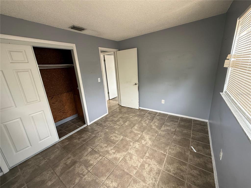 9275 Chase Street Spring Hill, FL 34606 - Photo 11 of 29 an empty room with windows