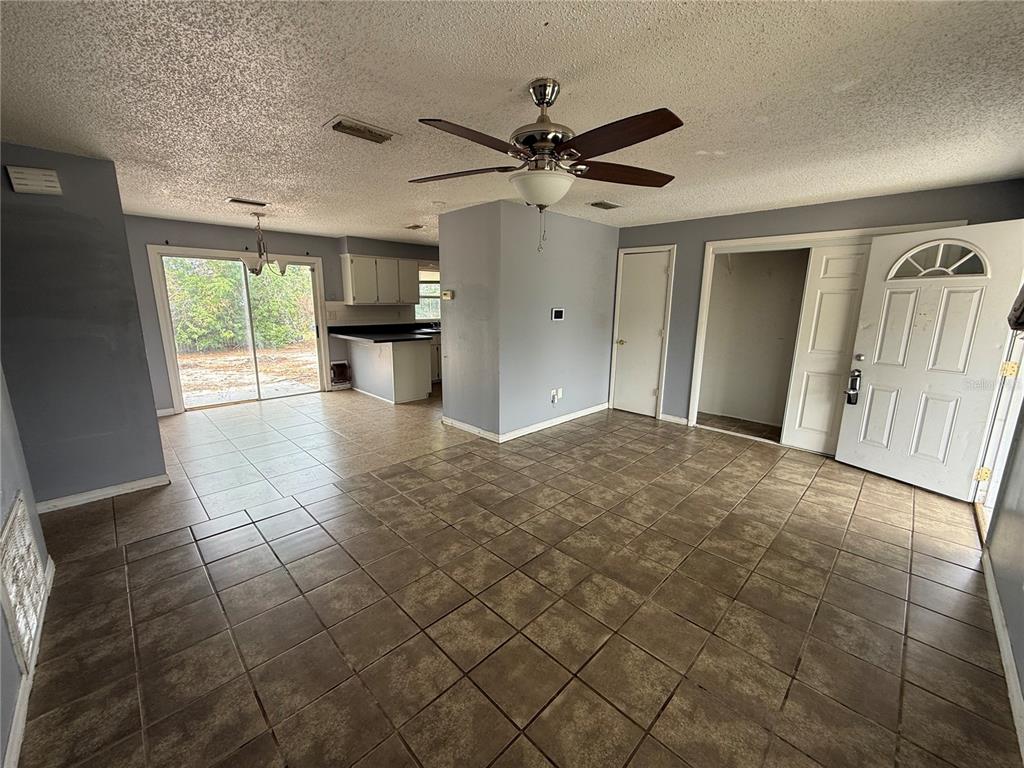 9275 Chase Street Spring Hill, FL 34606 - Photo 16 of 29 a view of a livingroom with a ceiling fan and window