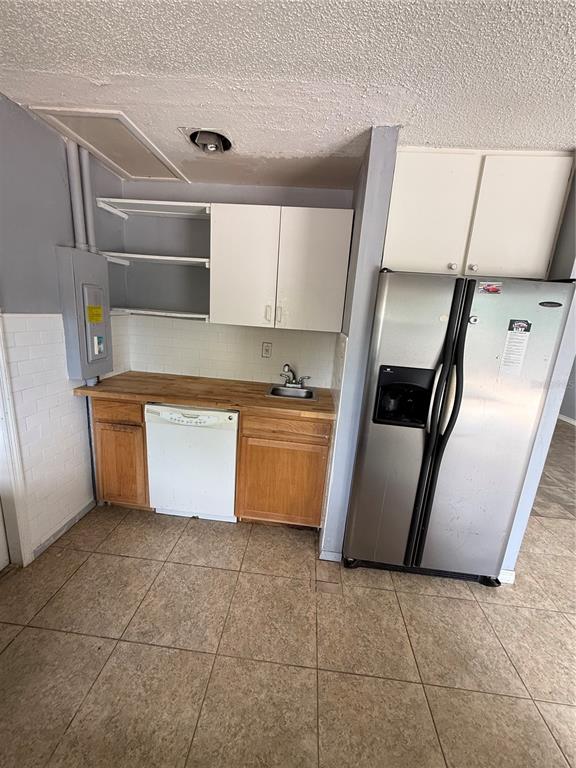 9275 Chase Street Spring Hill, FL 34606 - Photo 17 of 29 a kitchen with a refrigerator sink and cabinets