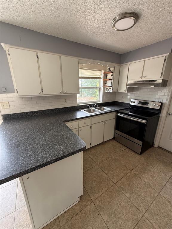 9275 Chase Street Spring Hill, FL 34606 - Photo 18 of 29 a kitchen with stainless steel appliances granite countertop a sink and a stove