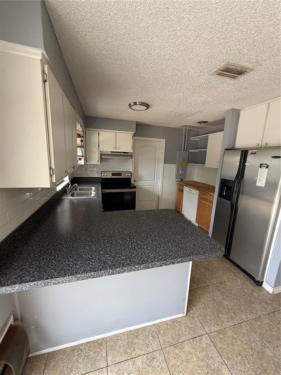 9275 Chase Street Spring Hill, FL 34606 - Photo 19 of 29 a kitchen with a sink a stove and cabinetry
