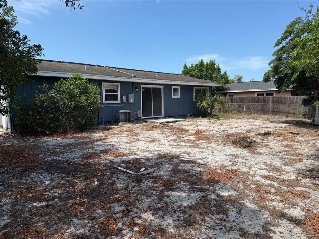 9275 Chase Street Spring Hill, FL 34606 - Photo 27 of 29 a front view of house with yard and trees in the background