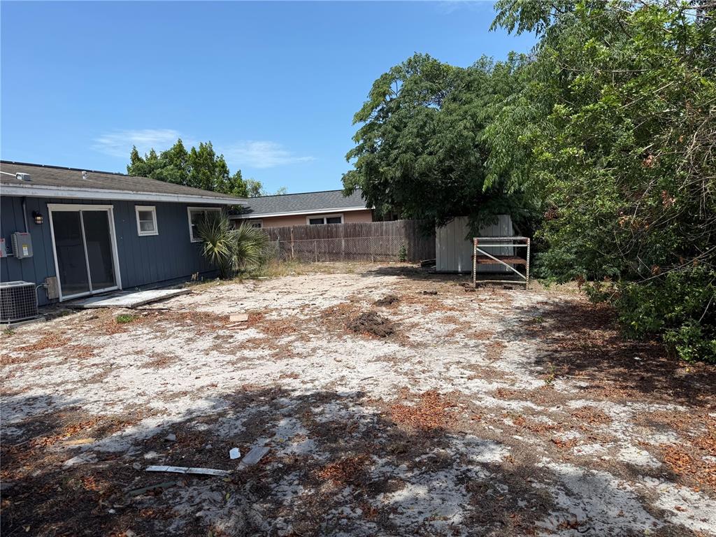 9275 Chase Street Spring Hill, FL 34606 - Photo 28 of 29 a backyard of a house with table and chairs