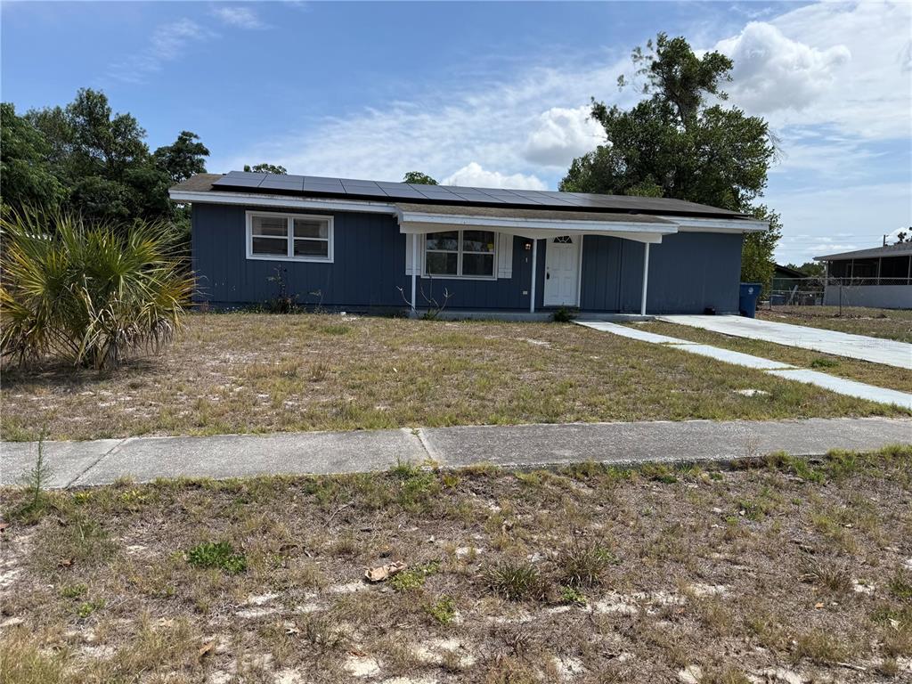 9275 Chase Street Spring Hill, FL 34606 - Photo 4 of 29 a front view of a house with a garden