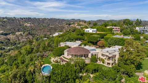 a view of a house with a swimming pool and yard
