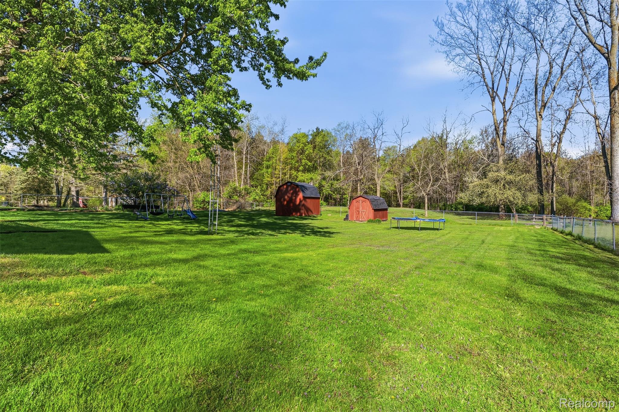 14433 Tuscola Road Clio, MI 48420 - Photo 33 of 43 Fenced backyard with a shed and a trampoline
