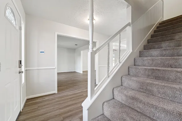 a view of entryway and hall with wooden floor