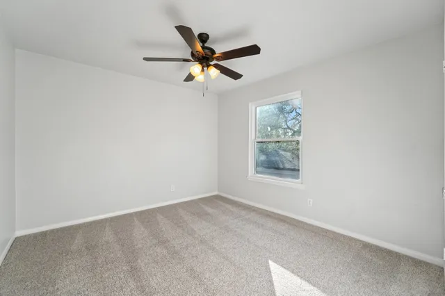 a view of room with window and ceiling fan
