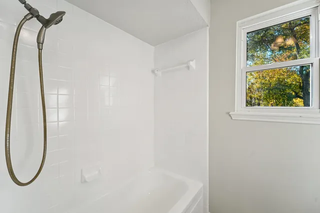 a bathroom with a shower and a mirror