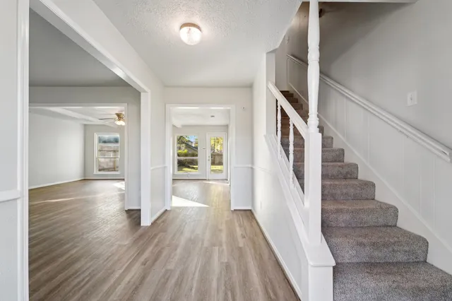 a view of a hallway view with wooden floor and staircase
