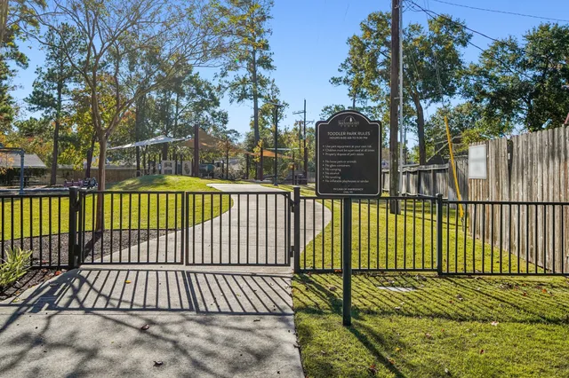 a street sign on a sidewalk next to a road