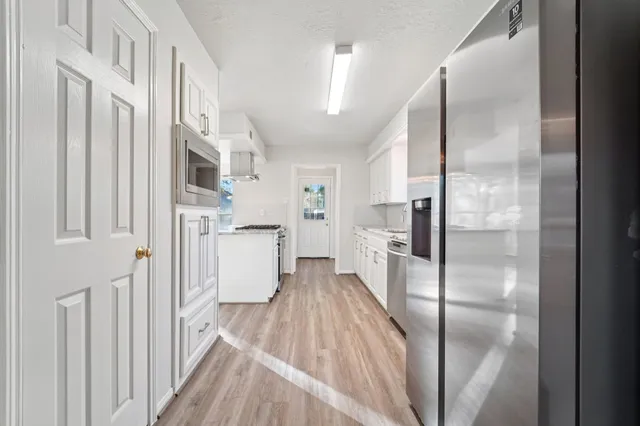 a view of a kitchen with a refrigerator in a kitchen