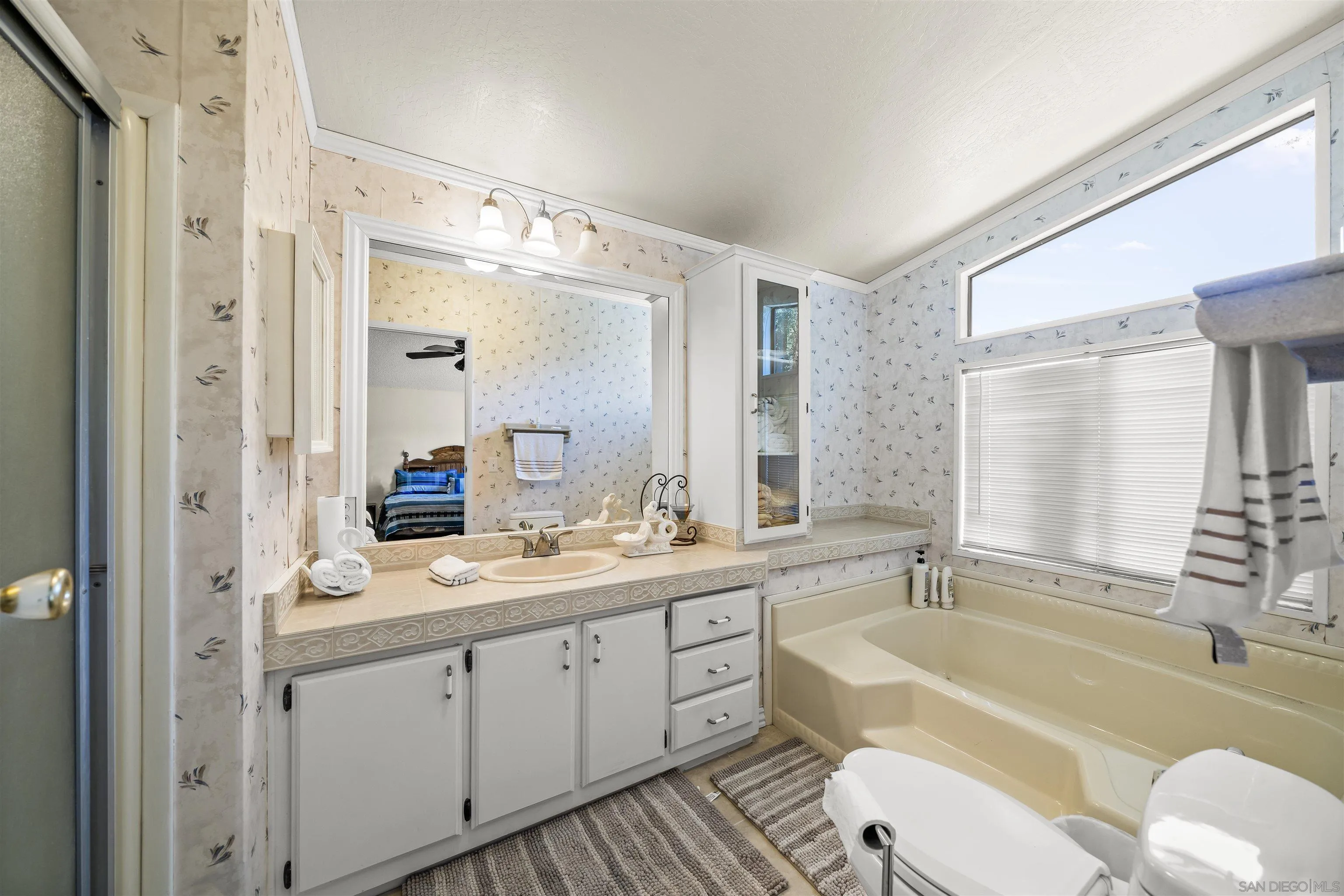 2464 Wynola Road Julian, CA 92036 - Photo 31 of 50 a bathroom with a granite countertop bathtub shower sink mirror and toilet