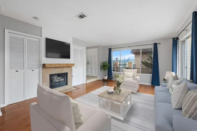 a living room with furniture a fireplace and a flat screen tv