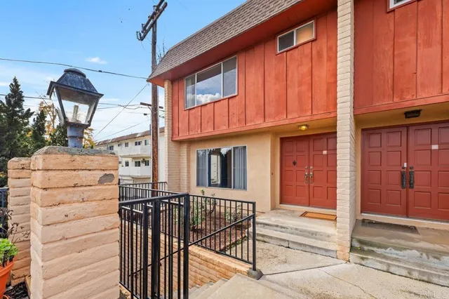 a view of a house with wooden fence and windows