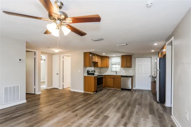 a view of a kitchen with a refrigerator and microwave