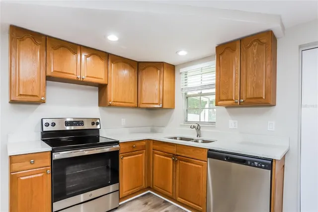a kitchen with granite countertop cabinets stainless steel appliances and a sink