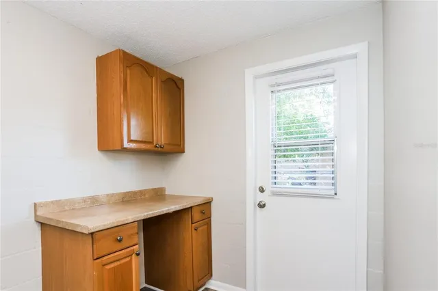 a utility room with a sink a vanity and a window