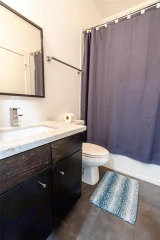 a bathroom with a sink a toilet and mirror