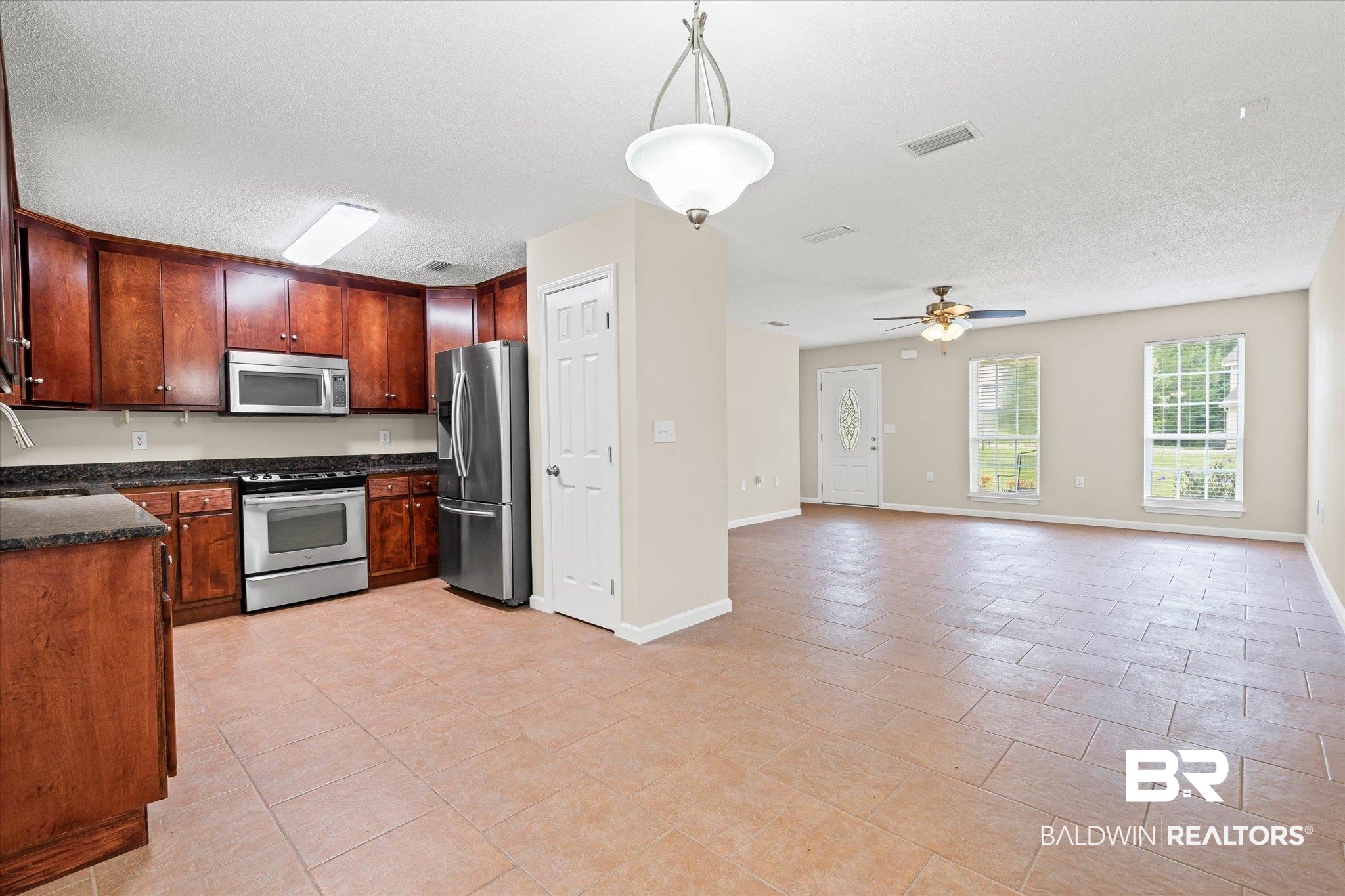157 Bay View Drive Daphne, AL 36526 - Photo 21 of 22 Kitchen with pendant lighting, stainless steel appliances, a textured ceiling, a ceiling fan, and open floor plan