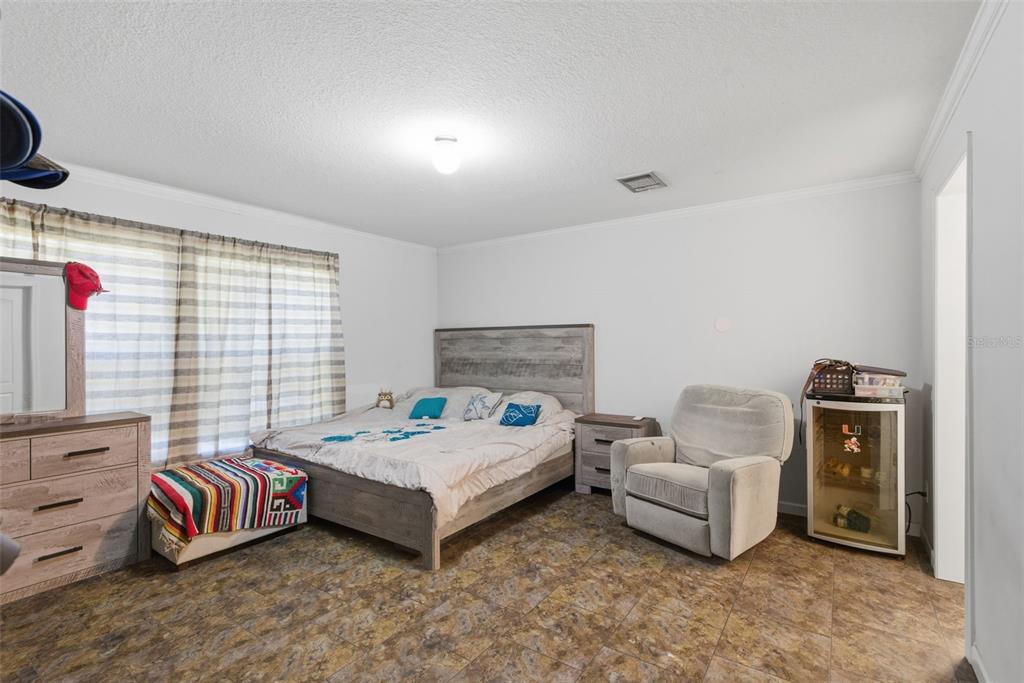 5022 Carol Drive Wesley Chapel, FL 33543 - Photo 13 of 25 a bedroom with bed and a flat screen tv