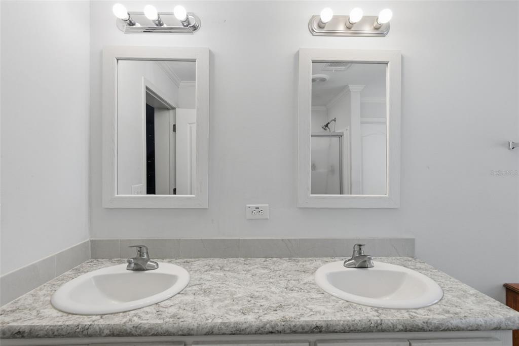 5022 Carol Drive Wesley Chapel, FL 33543 - Photo 16 of 25 a bathroom with sink granite and a mirror