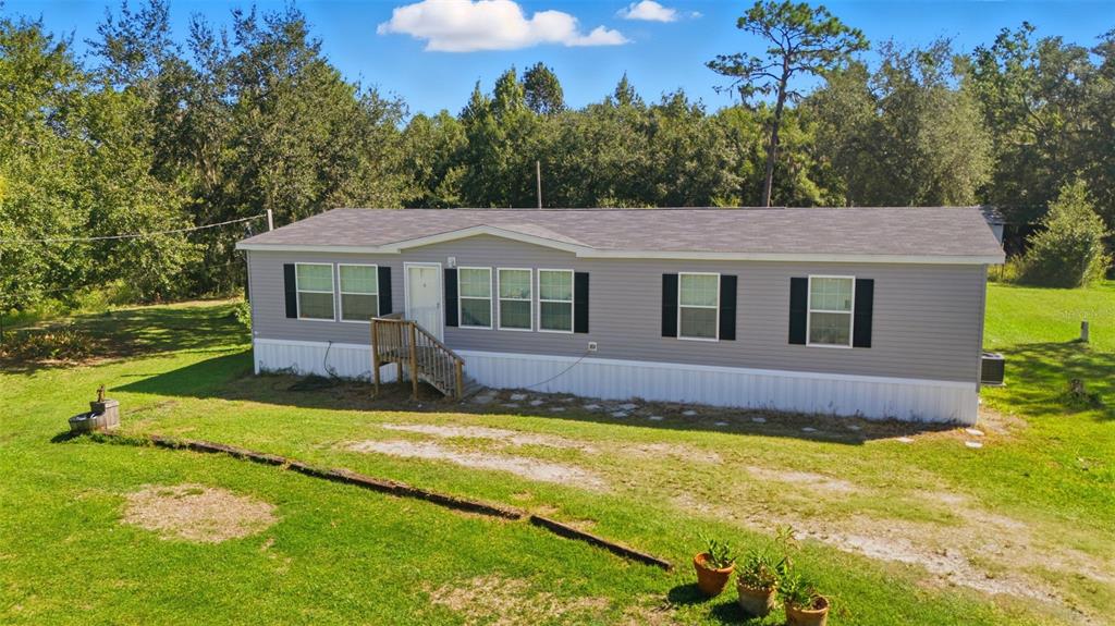 5022 Carol Drive Wesley Chapel, FL 33543 - Photo 2 of 25 a view of a house with swimming pool next to a yard