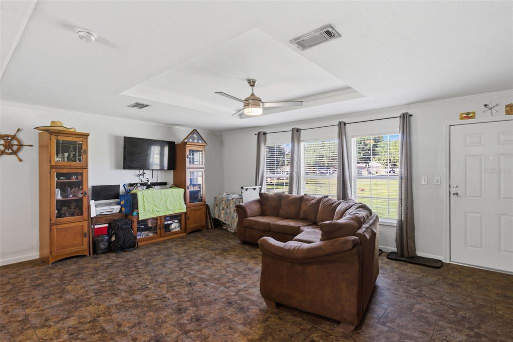 5022 Carol Drive Wesley Chapel, FL 33543 - Photo 3 of 25 a living room with furniture and a flat screen tv