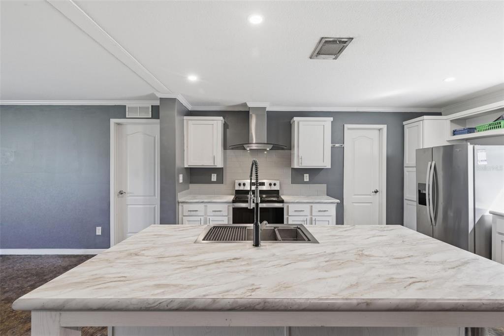 5022 Carol Drive Wesley Chapel, FL 33543 - Photo 5 of 25 a large bedroom with a bed and a large mirror