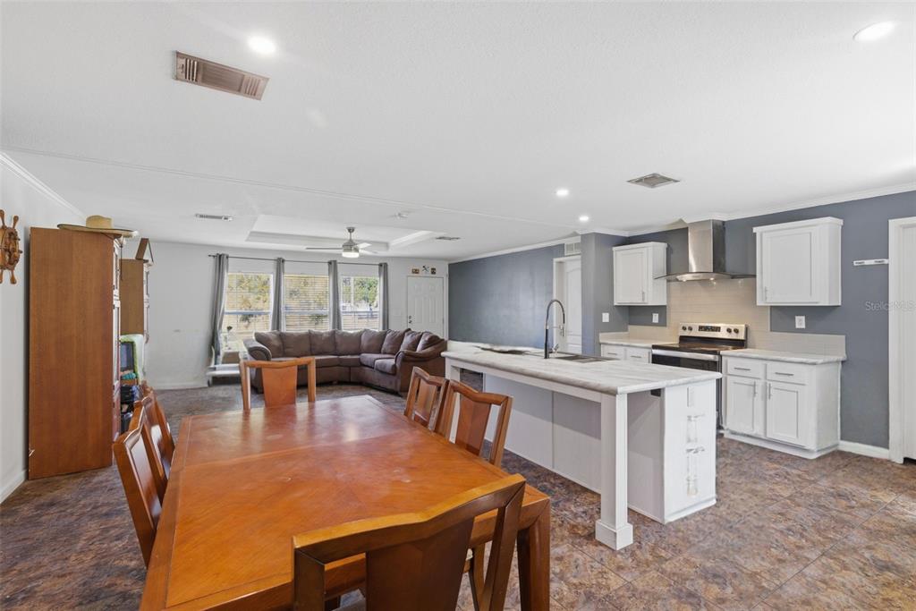 5022 Carol Drive Wesley Chapel, FL 33543 - Photo 8 of 25 a large kitchen with a table and chairs