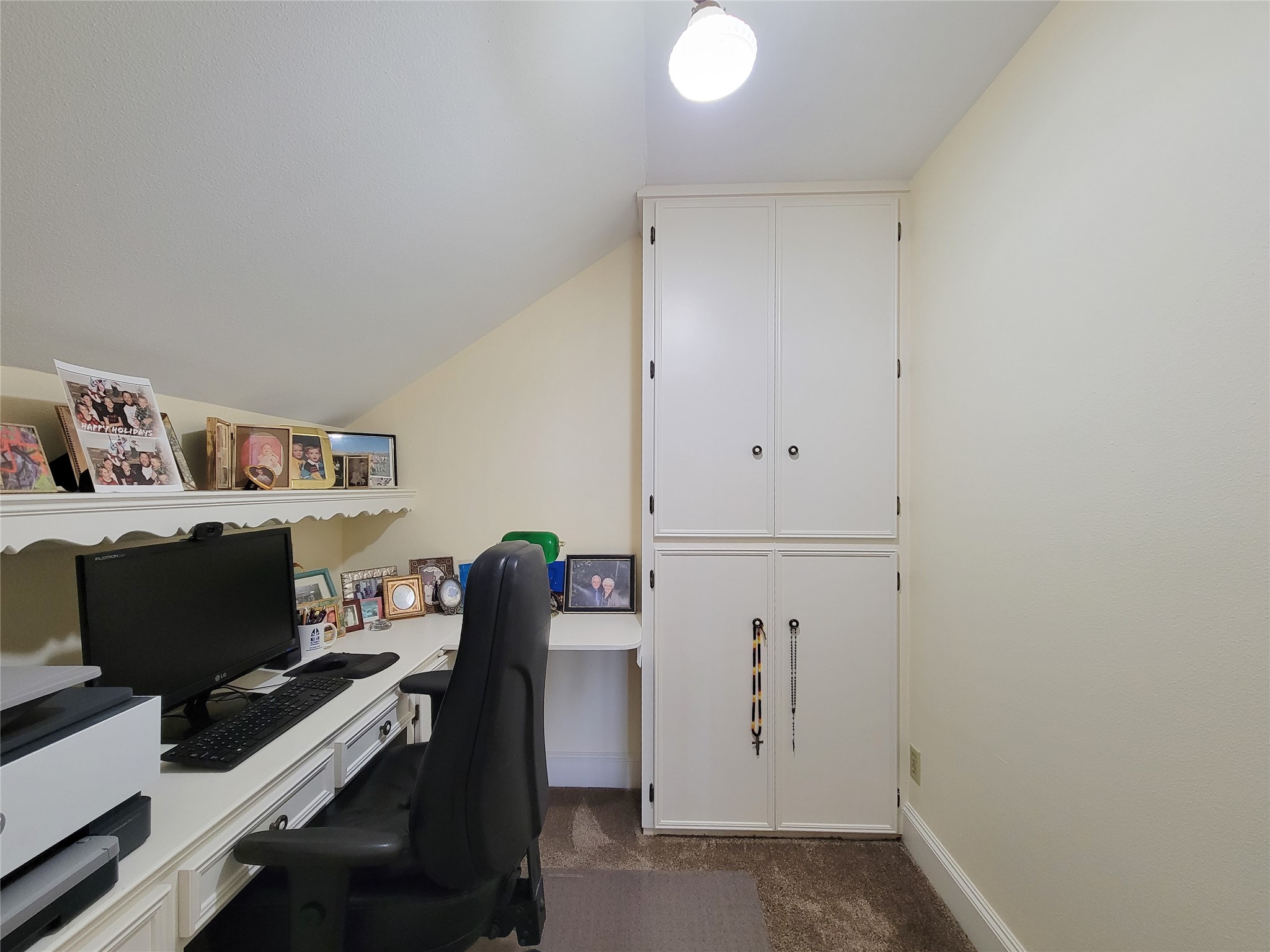 1406 Key Street Brenham, TX 77833 - Photo 23 of 50 Discover a cozy study room next to the upstairs living area, featuring a built-in desk and ample cabinets.