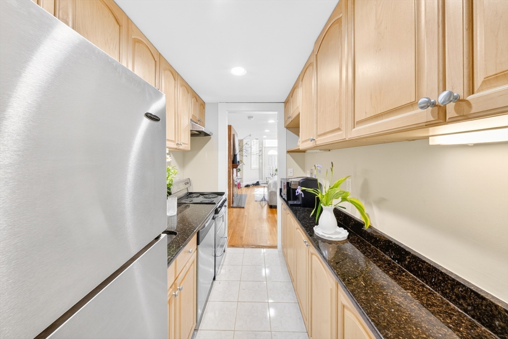 352 Tappan Street, Unit 1 Brookline, MA 02445 - Photo 16 of 42 a view of a kitchen with kitchen island wooden floor and stainless steel appliances
