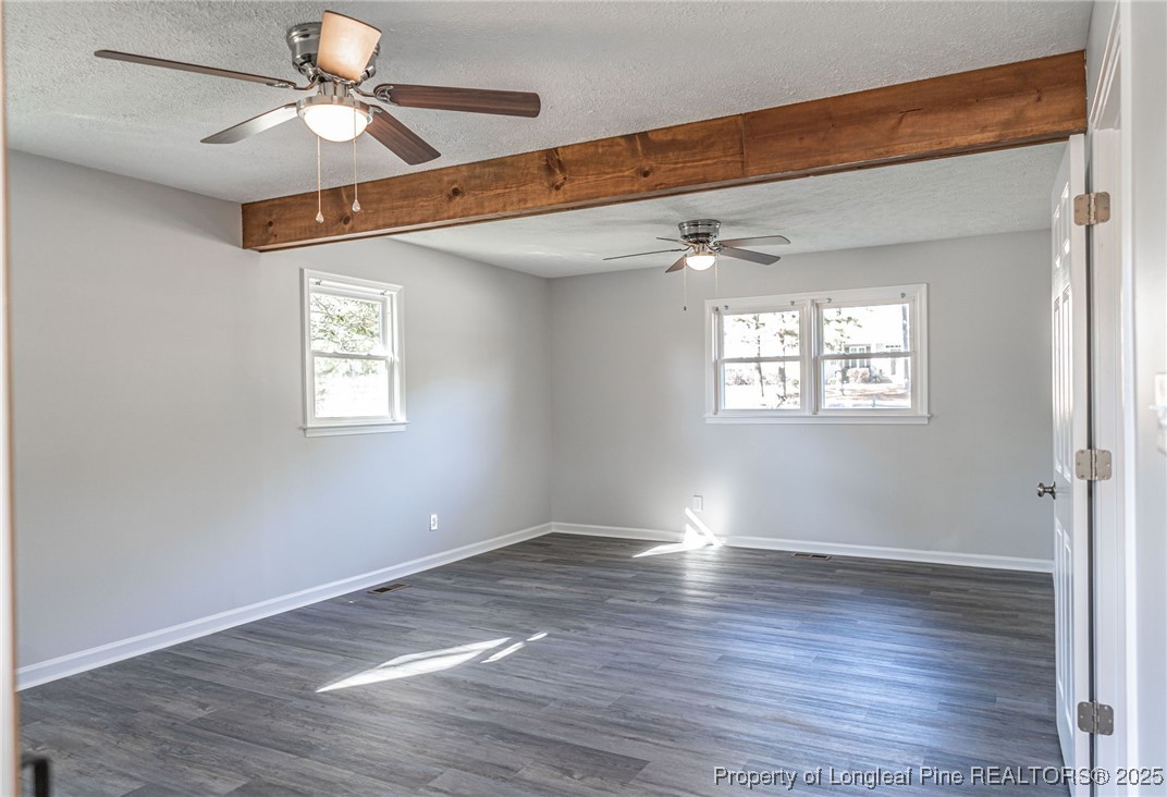 255 Foxcroft Road Whispering Pines, NC 28327 - Photo 24 of 31 a view of an empty room with wooden floor and a window