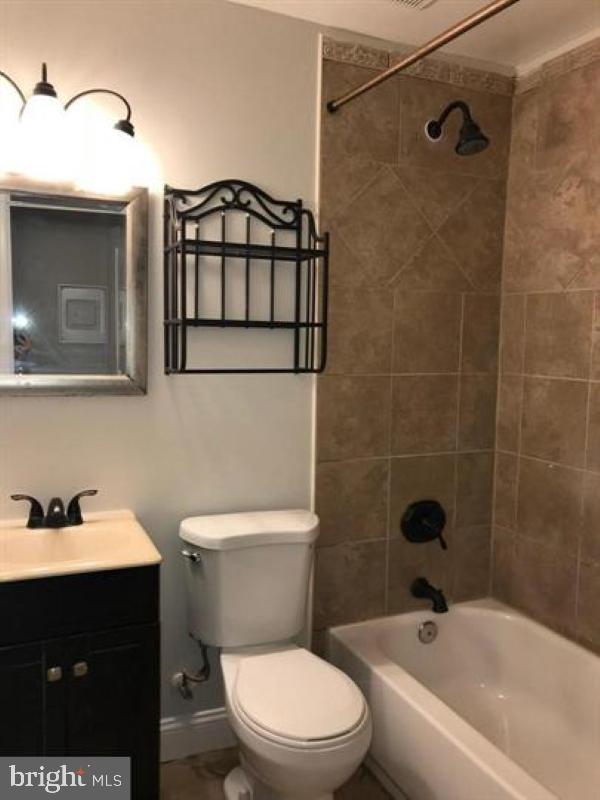 1106 Gleneagle Road, Unit 2 Baltimore, MD 21239 - Photo 6 of 10 a bathroom with a sink a toilet and shower