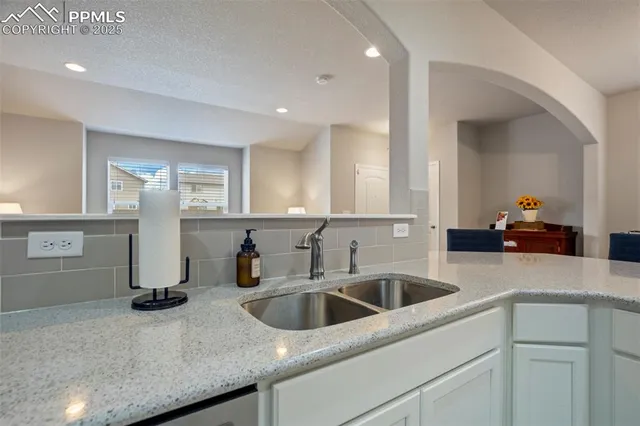 a kitchen with a sink and cabinets