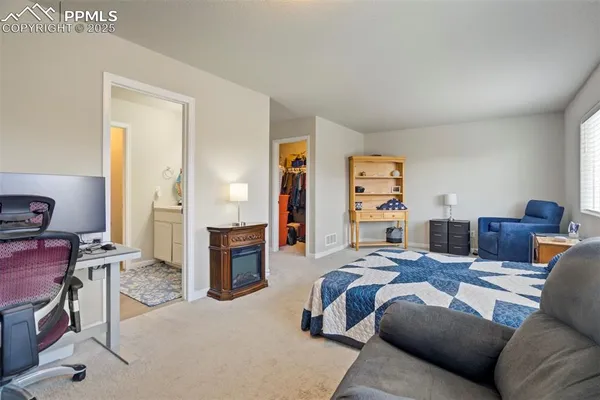 a bedroom with furniture and a wooden floor