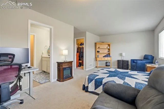a bedroom with furniture and a wooden floor