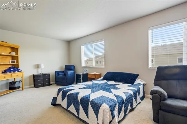 a bedroom with a bed and a couch
