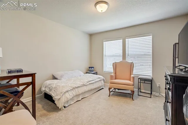 a bedroom with a bed chair and a desk