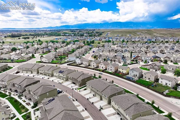an aerial view of residential houses with yard