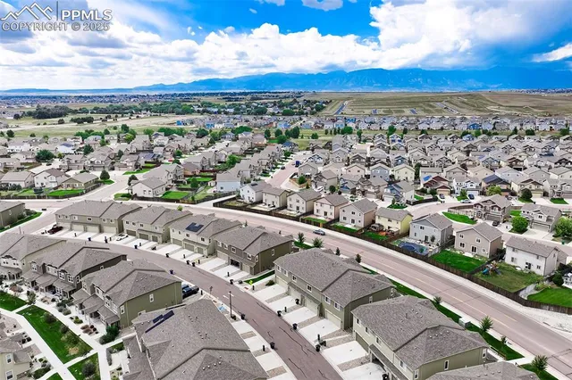 an aerial view of residential houses with yard