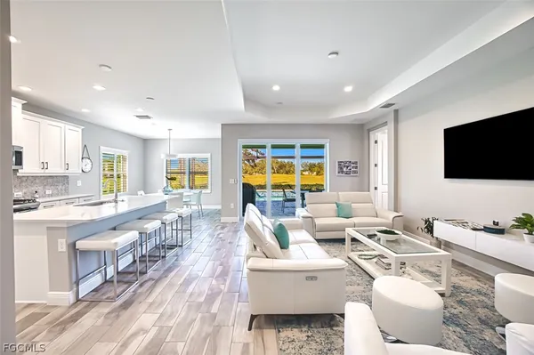 a living room with lots of furniture and a flat screen tv