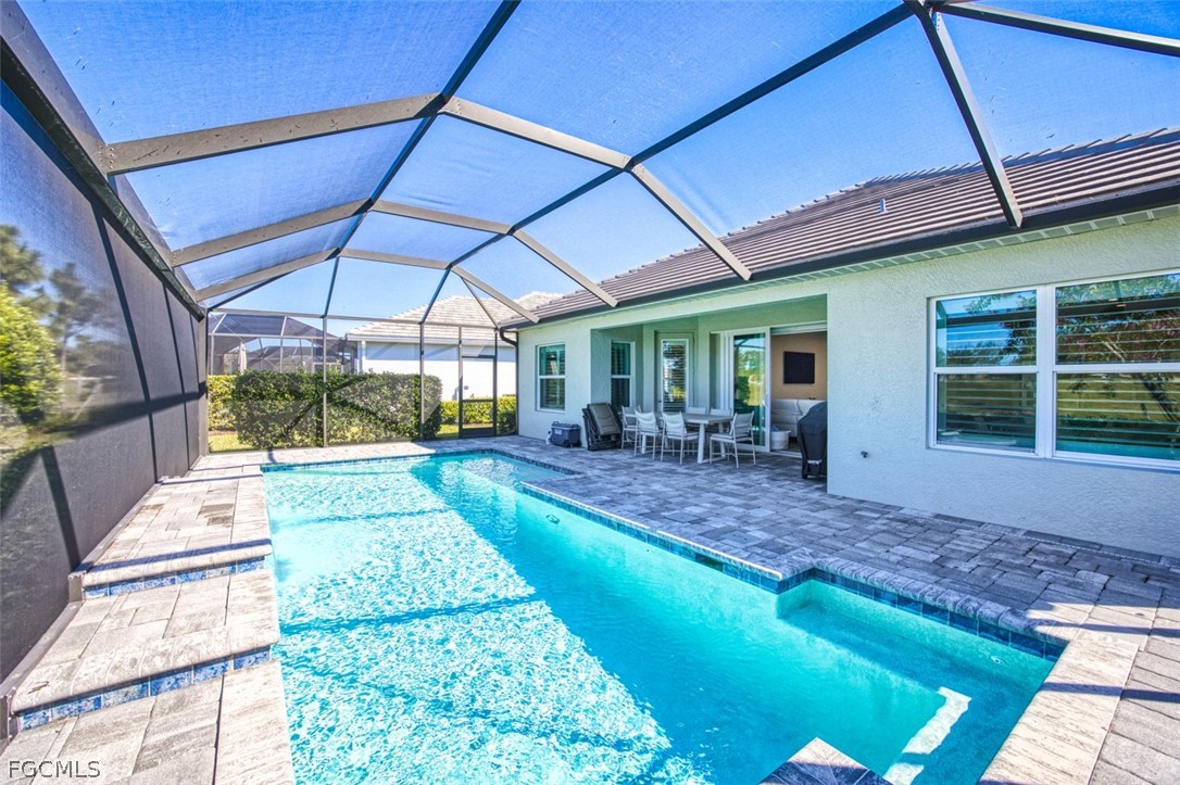 2925 Willow Ridge Court Fort Myers, FL 33905 - Photo 19 of 50 a view of a backyard with a patio and a yard
