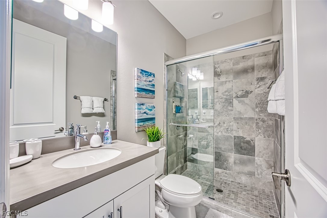 2925 Willow Ridge Court Fort Myers, FL 33905 - Photo 22 of 50 a bathroom with a shower sink vanity mirror and toilet
